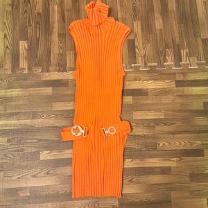 This orange in color turtle neck blouse is from Tracy M. And the size is M